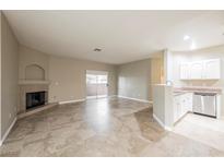 Open-concept living area with tile floors, fireplace, and sliding door access at 2050 W Warm Springs Rd # 4322, Henderson, NV 89014