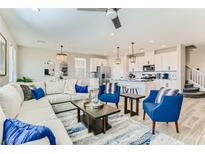 A spacious living room featuring modern decor, plush seating, and an open floor plan with adjacent kitchen at 2417 Fasano St, Henderson, NV 89044