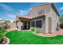 View of the house with a covered patio and a well-maintained lawn surrounded by decorative rock at 2529 Flodden St, Henderson, NV 89044