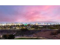 Expansive city views from this home nestled above a golf course offer an illuminated skyline at night at 2784 Cherrydale Falls Dr, Henderson, NV 89052