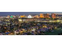 Panoramic aerial view of a residential area with the Las Vegas city skyline in the background at dusk at 3111 Bel Air Dr # 23A, Las Vegas, NV 89109