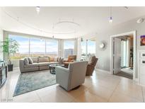 Bright living room featuring floor-to-ceiling windows and comfortable seating, perfect for entertaining at 322 Karen Ave # 2201, Las Vegas, NV 89109
