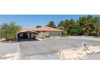 Charming ranch home with desert landscaping, orange tile roof and spacious driveway at 3360 National Ave, Pahrump, NV 89048