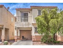 Charming two-story home boasts a balcony, well-maintained exterior, and beautiful desert landscaping, complete with cozy patio seating at 4037 Asante Cove St, Las Vegas, NV 89115