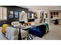 Modern living room with stylish furniture, light wood floors and a view into the kitchen at 464 Beardsley Cir, Henderson, NV 89052