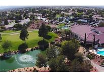 Stunning aerial view of a golf course community with a clubhouse, pool, and lush landscaping at 5028 Glenarden Dr, Las Vegas, NV 89130