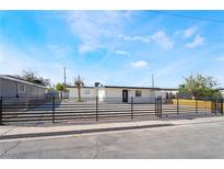 Charming single-story home featuring secure fencing, a modern aesthetic, and well-maintained landscaping at 5069 Hallet Dr, Las Vegas, NV 89122