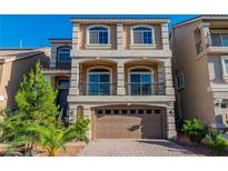 Charming two-story home boasts a well-maintained exterior with a brick driveway and attached two-car garage at 5889 Thistle Meadow Ave, Las Vegas, NV 89139
