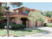 Inviting two-story home featuring a well-maintained front yard and a charming tiled roof at 7607 Boca Raton Dr, Las Vegas, NV 89113