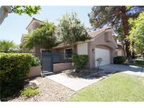 Charming home featuring a well-maintained yard, lovely landscaping, and an attached two car garage at 912 Pro Players Dr, Las Vegas, NV 89134