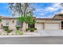 Charming single-story home featuring a well-manicured yard and a two-car garage at 9349 Olympia Falls Ave, Las Vegas, NV 89149