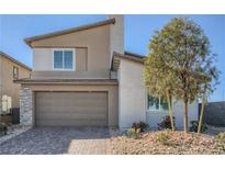 Charming two-story home with a two-car garage and low maintenance desert landscaping in a Gathering-friendly neighborhood at 9564 Archer Peak Ct, Las Vegas, NV 89143