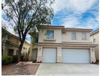 Two-story home with a two-car garage, landscaped front yard, and neutral-colored facade at 9821 Sedona Shrine Ave, Las Vegas, NV 89148