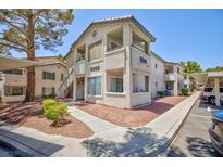 Condominium exterior featuring neutral stucco, walkway, and covered parking in a sunny community at , Las Vegas, NV 89120