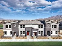 Modern two-story townhome featuring a striking color scheme and inviting front entrances, set against a scenic mountain backdrop at , North Las Vegas, NV 89084