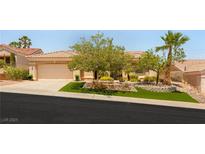 Charming single-story home with a well-manicured lawn and mature trees enhancing its curb appeal at 10404 Long Leaf Pl, Las Vegas, NV 89134