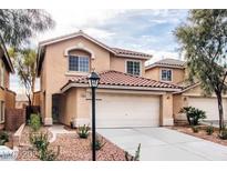 Two story home showcasing desert landscaping, a red tile roof, and a two car garage at 11029 Meadow Leaf Ave, Las Vegas, NV 89144