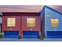 Stylish townhomes showcasing modern architecture with vibrant, complementary colors and private garage entrances at 1190 E Carson Ave, Las Vegas, NV 89101