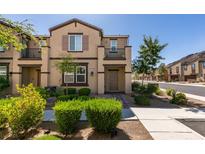 Inviting two-story townhome with a well-maintained lawn, lovely landscaping, and an attractive front entrance at 1200 Mission View Ct, Henderson, NV 89002
