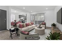 Bright living room featuring neutral decor, comfortable seating, and an open layout to the dining and kitchen area at 1390 Vegas Valley Dr # 26, Las Vegas, NV 89169