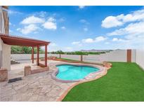 Backyard with a pergola covered patio, pool, and turf at 1611 Buffalo Trail Dr, Henderson, NV 89014