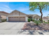 Charming single-story home featuring a well-manicured yard, two-car garage, and desert landscaping at 1763 Crystal Stream Ave, Henderson, NV 89012
