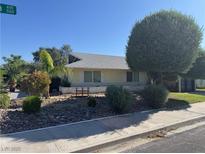 Charming single-story home featuring lush landscaping and mature trees, offering privacy and curb appeal at 1819 Beverly Way, Las Vegas, NV 89104
