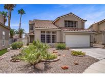 Charming two-story home with a well-maintained front yard, desert landscaping, and a two-car garage at 270 Snowy River Cir, Henderson, NV 89074