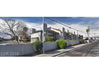 The exterior of this apartment building has a cinder block wall and ample landscaping around the property at 2981 Country Manor Ln # 118, Las Vegas, NV 89115