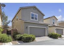 Charming two-story home features a gray exterior, a well-kept lawn, and a two-car garage at 3132 Cartanda Ave, Henderson, NV 89044