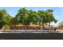 Charming single-story home with mature trees and a brick perimeter wall at 3250 Duneville St, Las Vegas, NV 89146