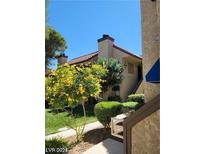 Inviting two-story condo with well-maintained landscaping and lush green lawn at 4720 Obannon Dr # D, Las Vegas, NV 89102
