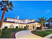 Stunning home boasts palm trees, arched windows, and a circular driveway at 5030 Spanish Hills Dr, Las Vegas, NV 89148