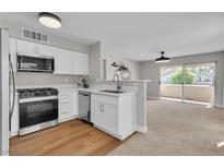 Bright kitchen featuring white cabinets, stainless steel appliances, and a modern aesthetic with an open concept design at 5710 E Tropicana Ave # 2152, Las Vegas, NV 89122