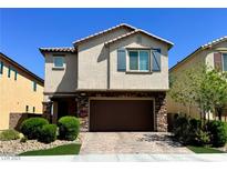 Charming two-story home with brick-accented facade, well-manicured landscaping, and a two-car garage at 6334 Orions Belt Peak St, North Las Vegas, NV 89031