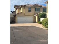 Two story home featuring an attached two car garage, desert landscaping, and a tile roof at 9329 Iceland Spar Ct, Las Vegas, NV 89148