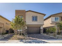 Charming two-story home featuring a brick-accented facade, two-car garage, and manicured landscaping at 9576 Archer Peak Ct, Las Vegas, NV 89143