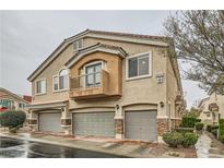 Charming townhome with private garages, a balcony and inviting curb appeal in a well-maintained community at 10147 Aspen Rose St # 101, Las Vegas, NV 89183