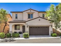 Charming two-story home with a well-manicured lawn and a two-car garage at 10353 Yew Blossom Ave, Las Vegas, NV 89166
