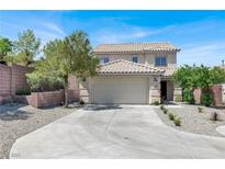 Two-story home featuring a tan exterior, tile roof, well-maintained landscaping, and a two-car garage at 10554 Lilac Tree Ave, Las Vegas, NV 89135