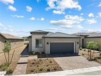 Charming single-story home featuring a brick driveway and desert landscaping at 171 Palm Fox Ct, Henderson, NV 89011