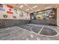 Indoor sports court featuring a basketball hoop, Vegas Golden Knights mural, and grey flooring at 2086 Troon Dr, Henderson, NV 89074