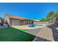 Inviting backyard showcasing a pool, a partially covered patio, and well-maintained landscaping at 2711 Briarcliff Ave, Henderson, NV 89074