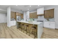 Spacious kitchen features an island with seating, modern appliances, and light wood cabinets at 2873 Knoxville Ct, Henderson, NV 89052