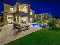 Backyard featuring a private pool, lounge chairs, and covered patio, perfect for outdoor relaxation and entertaining at 3 Hilltop Crest St, Henderson, NV 89011