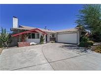 Charming single story home featuring a spacious driveway, two car garage, and landscaped front yard at 3382 Berwyck St, Las Vegas, NV 89121