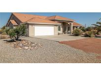 Charming single-story home featuring a spacious driveway and an attached two-car garage at 3430 Flagstone Ct, Pahrump, NV 89048
