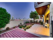 Private backyard with patio, desert landscaping, and city views at night at 3942 Delos Dr, Las Vegas, NV 89103