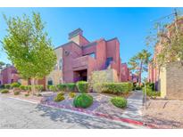 A colorful two-story condo with vibrant landscaping at 4050 Pacific Harbors Dr # 107, Las Vegas, NV 89121
