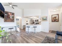 Bright living room featuring sleek floors, modern furnishings, and an open layout to the kitchen at 515 Kristin Ln, Henderson, NV 89011